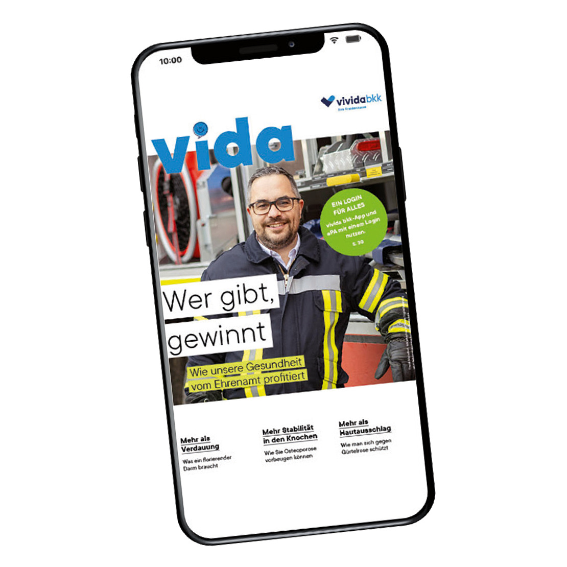 Ein Smartphone zeigt ein Zeitschriftencover mit einem lächelnden Mann in einer Feuerwehruniform. Die Zeitschrift trägt den Titel "vida" und enthält einen deutschen Text über die gesundheitlichen Vorteile von ehrenamtlichem Engagement. Das vividabkk-Logo erscheint oben rechts.
