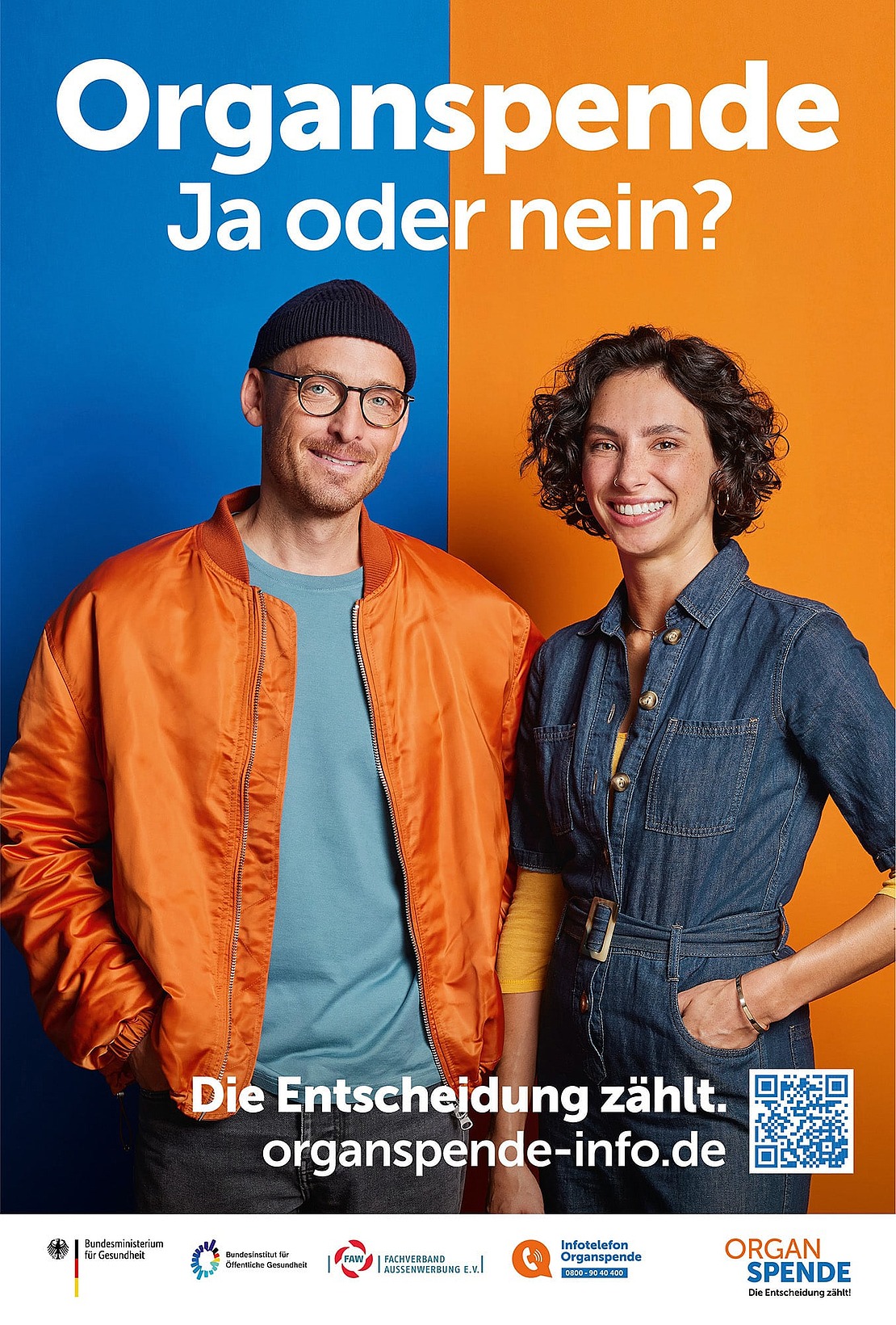 Zwei lächelnde Menschen stehen vor einem in Blau und Orange geteilten Hintergrund. Der Text lautet "Organspende - Ja oder nein?" und zeigt einen QR-Code mit Informationen zur Organspende in Deutschland.